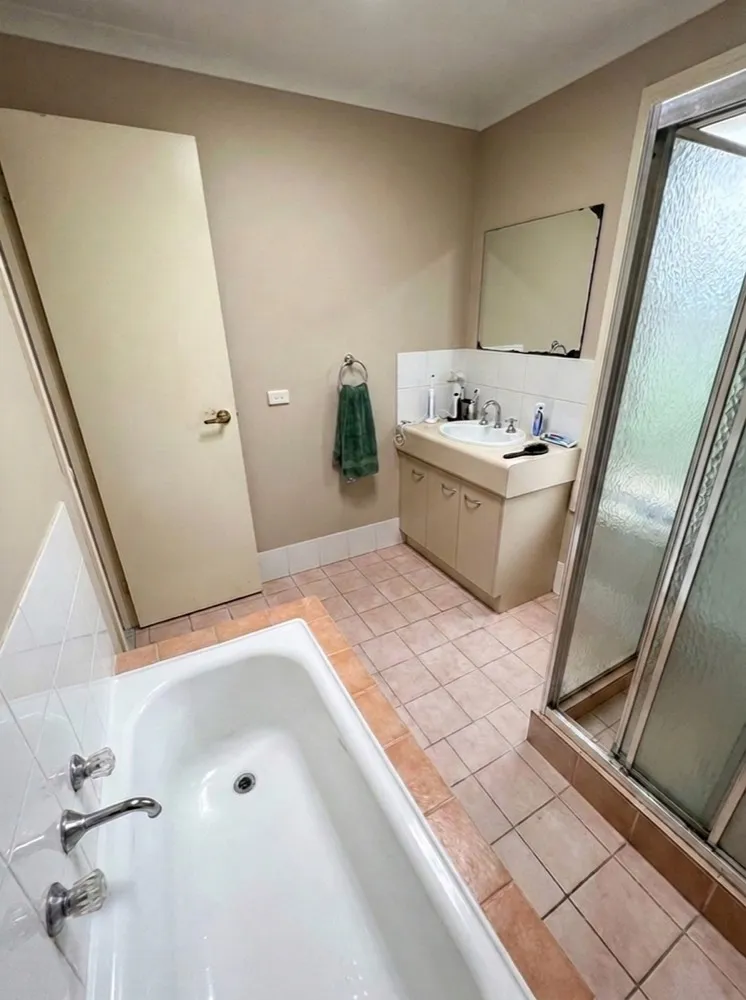Dated bathroom with old tub before renovation