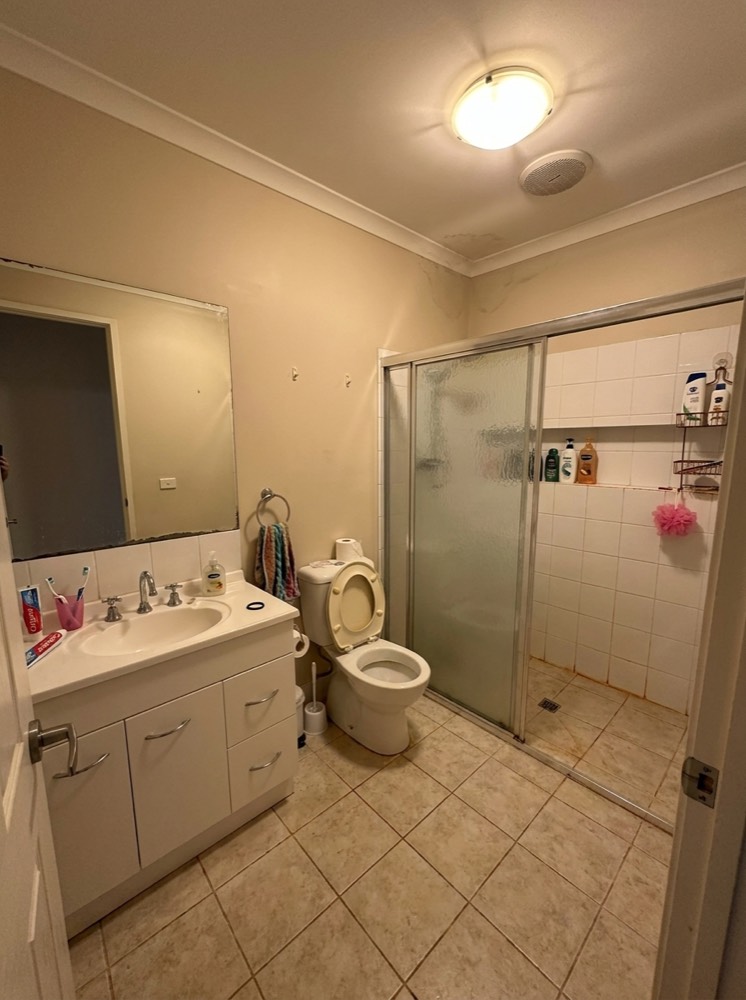 Dated beige bathroom before renovation
