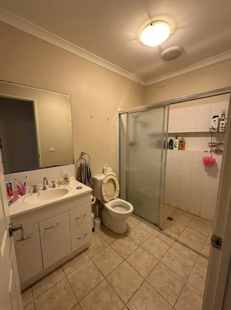 Dated beige bathroom before renovation