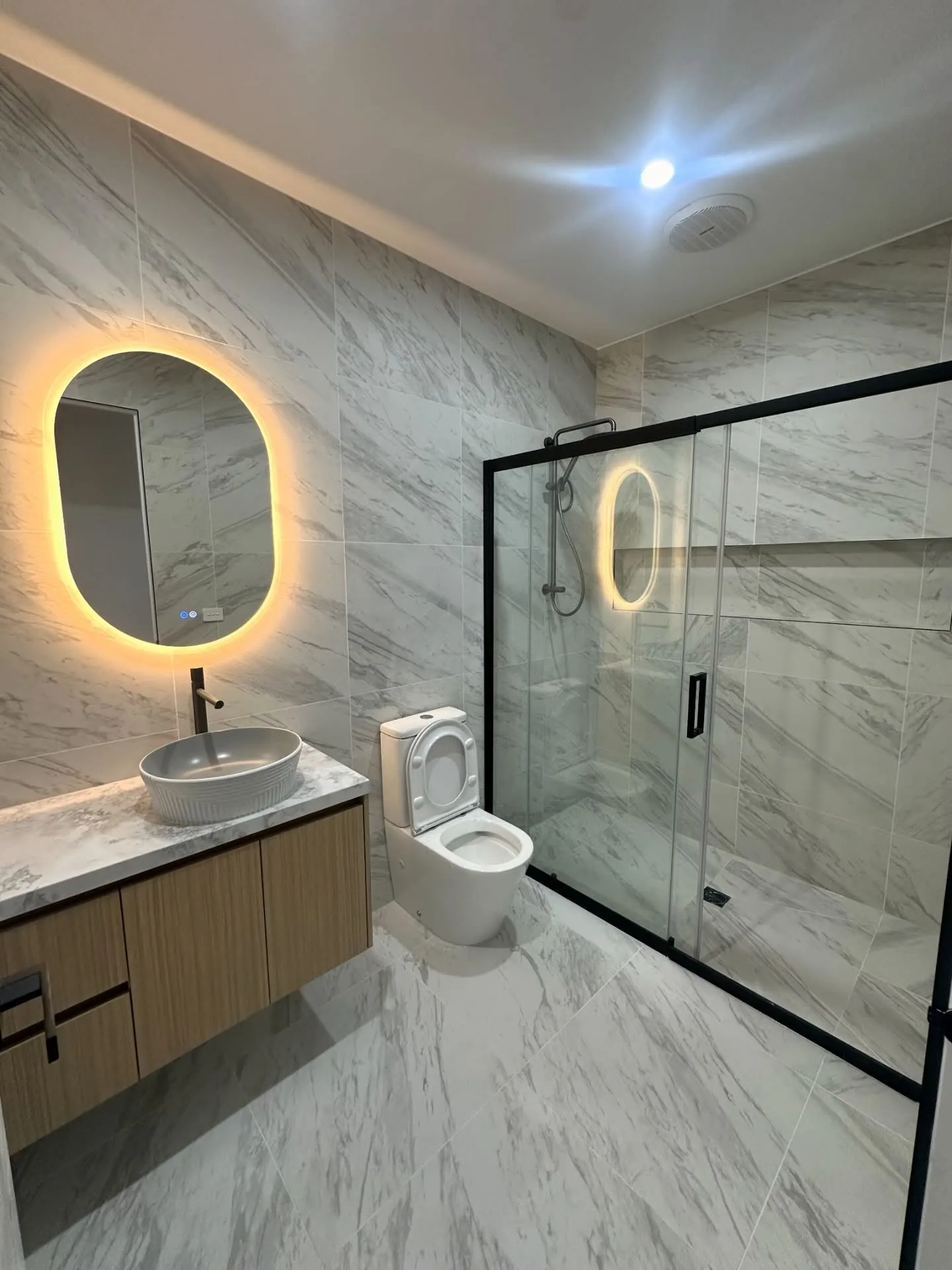 Marble bathroom with backlit LED mirror