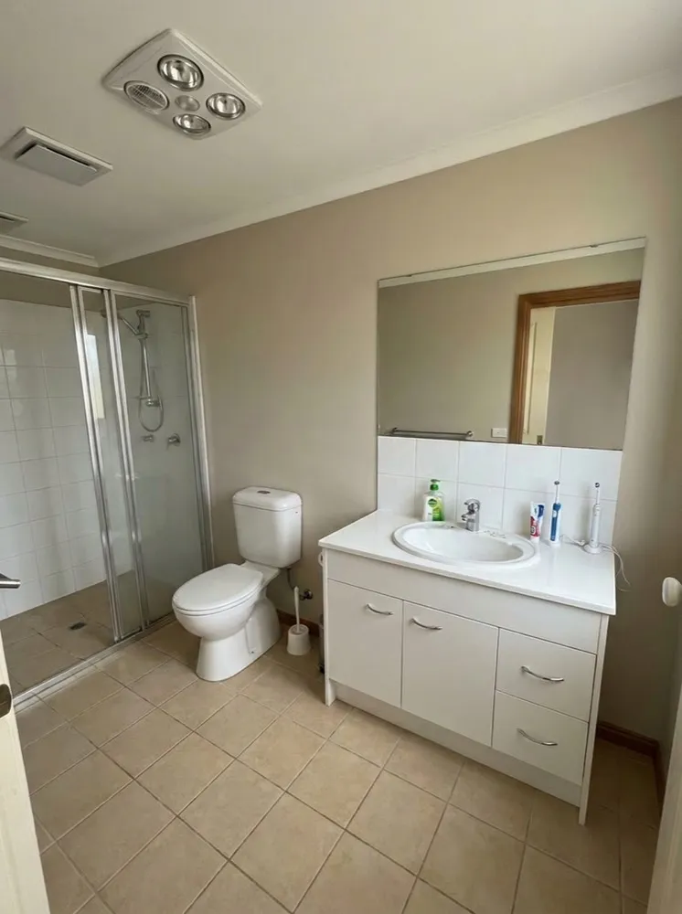 Dated beige bathroom before renovation