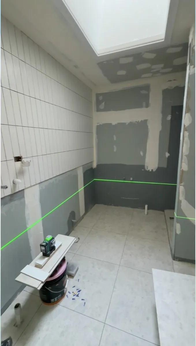 Waterproofing membrane applied to walls and floor, set out with a laser level